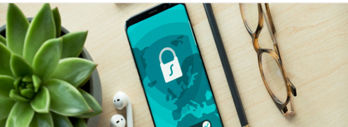Phone displaying a security lock beside office items